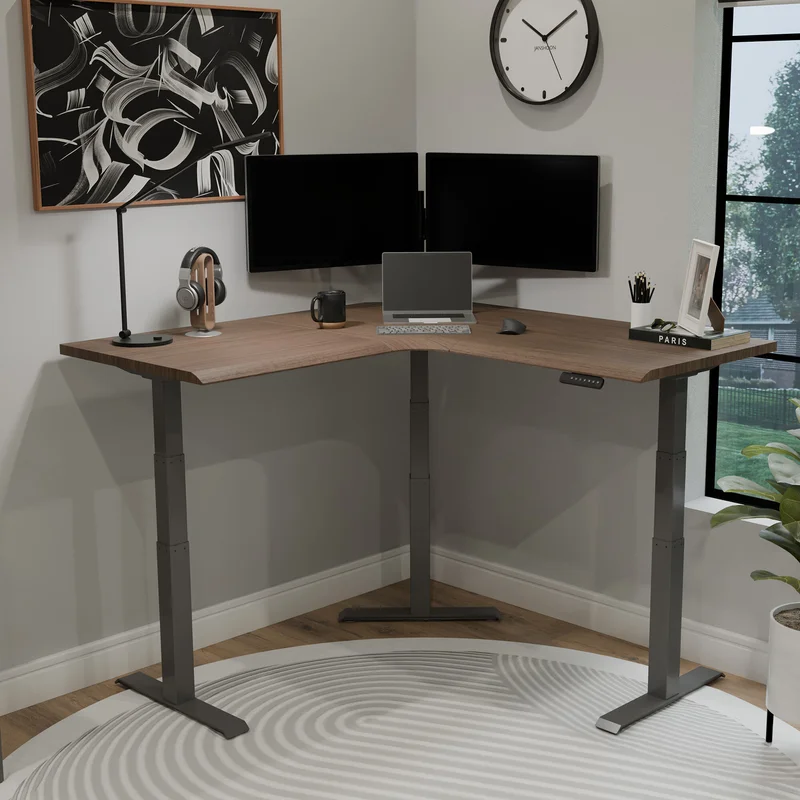 Vari Electric L-Shaped corner standing desk with dual monitors and solid walnut finish