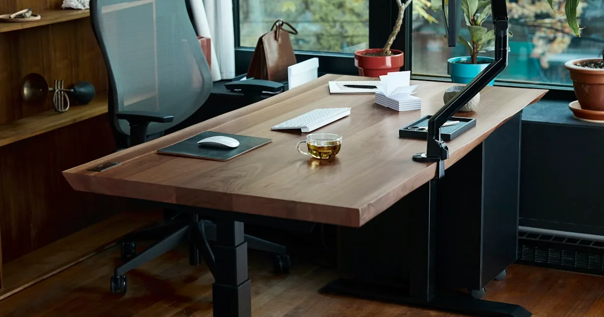 Person working at a standing desk with ergonomic setup